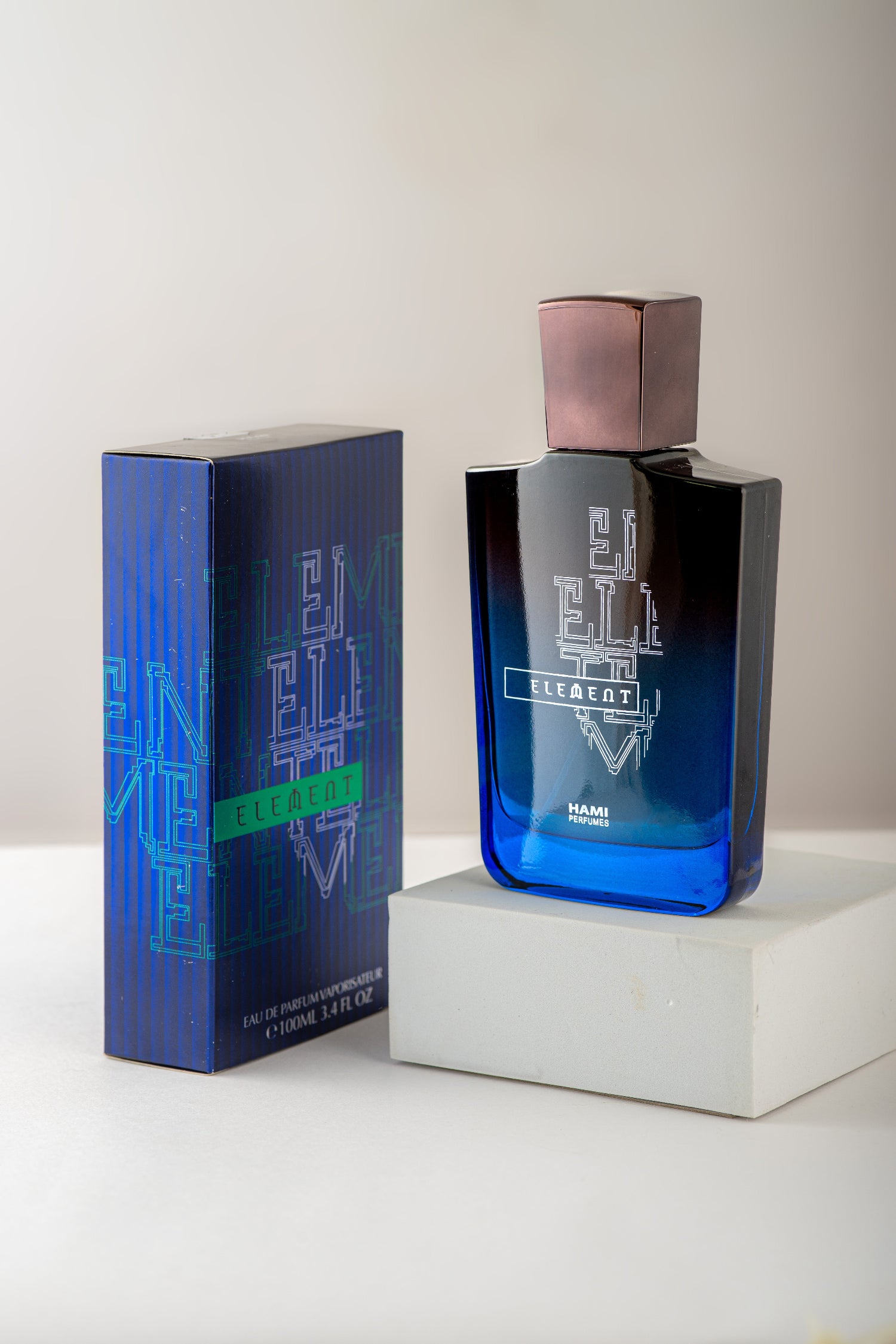 Blue perfume bottle and packaging on a white surface with a light gray background