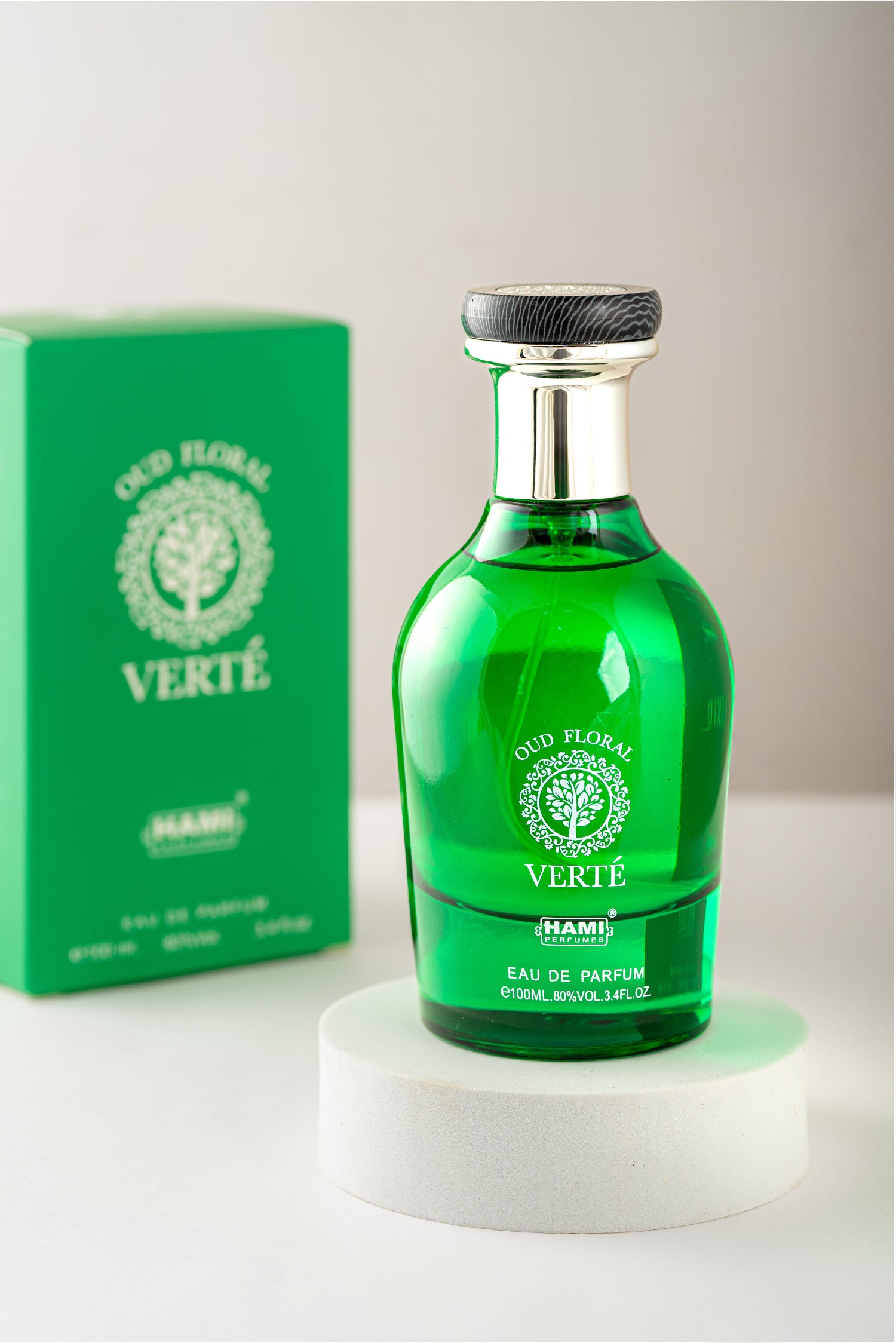 Green perfume bottle with 'Verte' packaging on a white surface