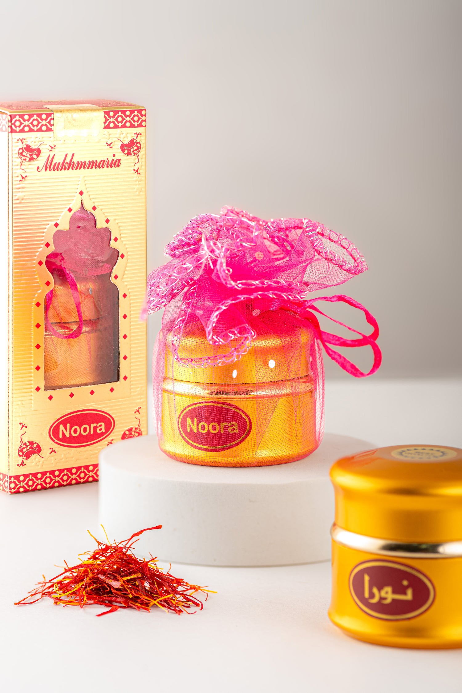 Noora product with packaging and saffron on a white surface